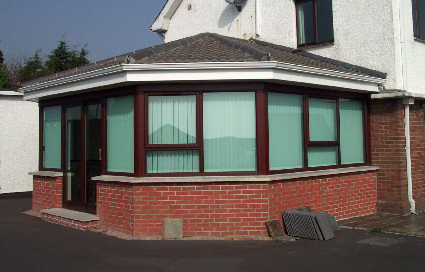 Rosewood uPVC sunroom with a tiled roof