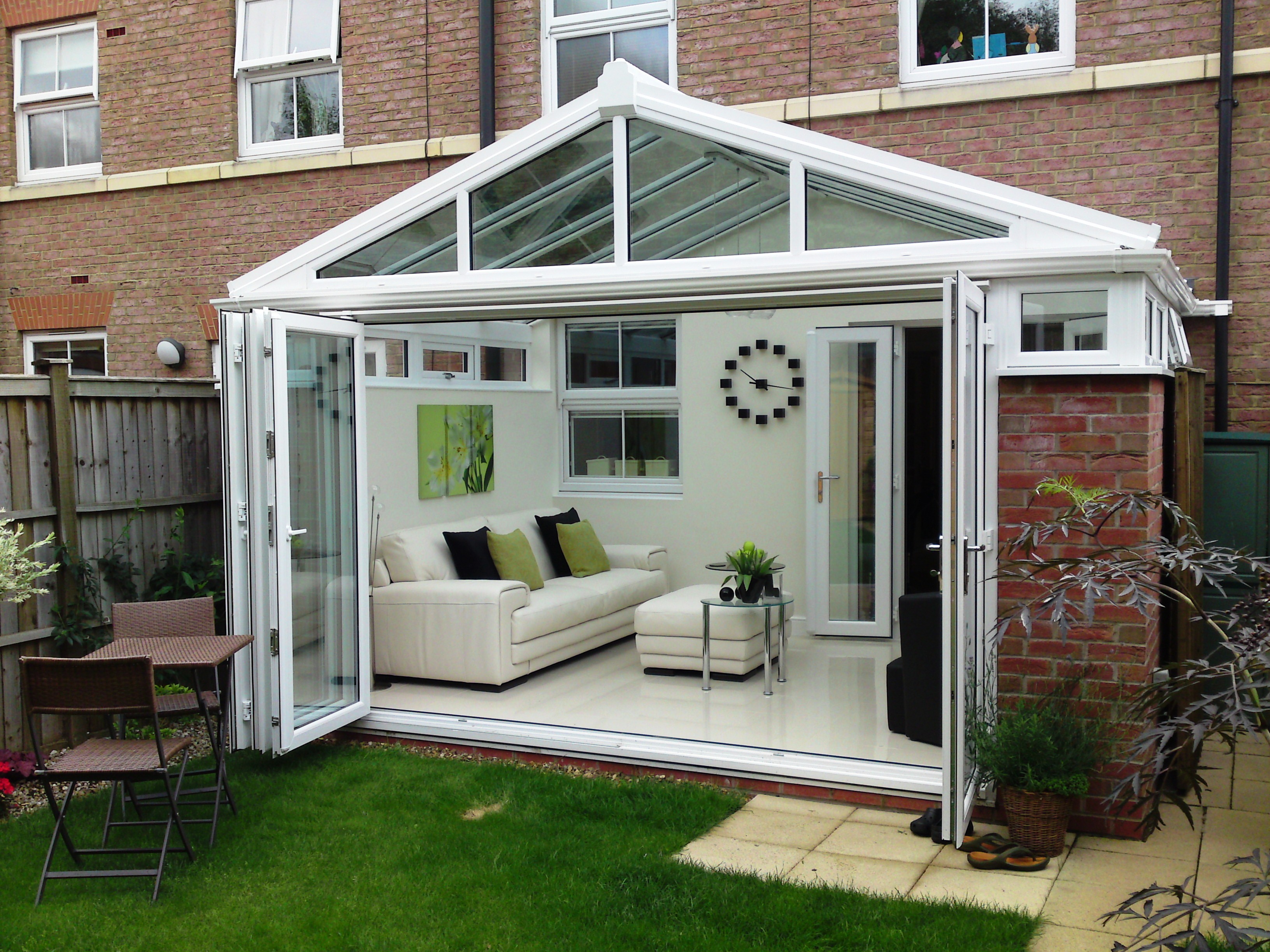 Ultraframe conservatory with open bifold doors.